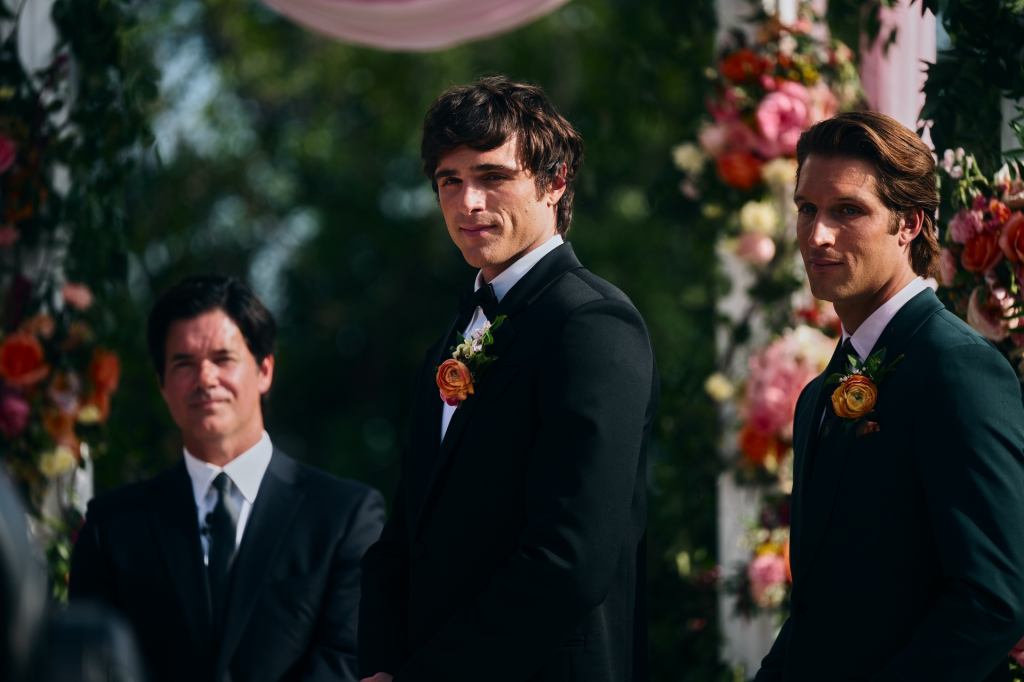 Jacob Elordi, as Nate Jacobs in Euphoria, standing with two other men dressed in suits and boutonnières.