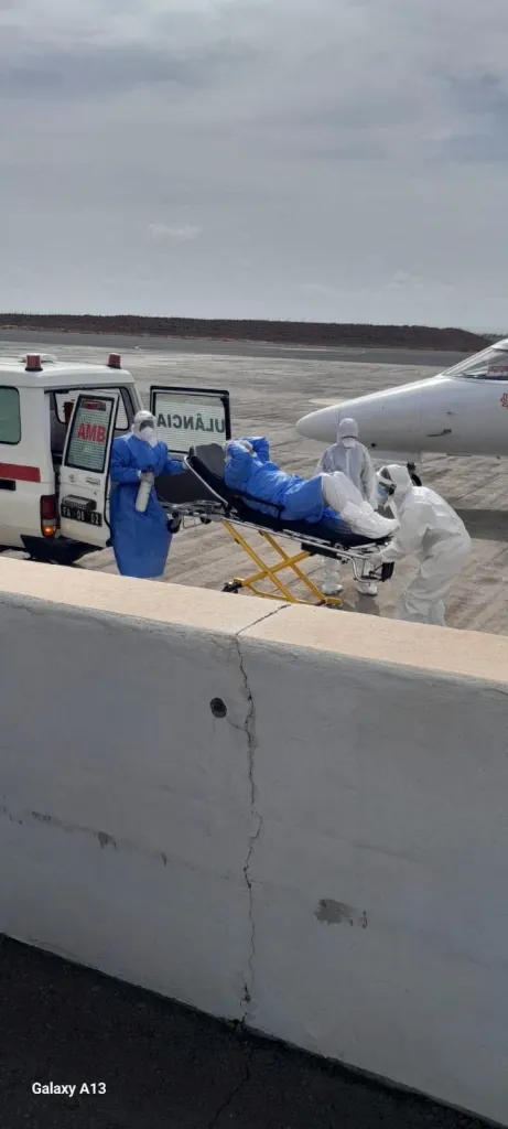 An evacuation operation of suspected hantavirus patients being moved from an ambulance to a plane.