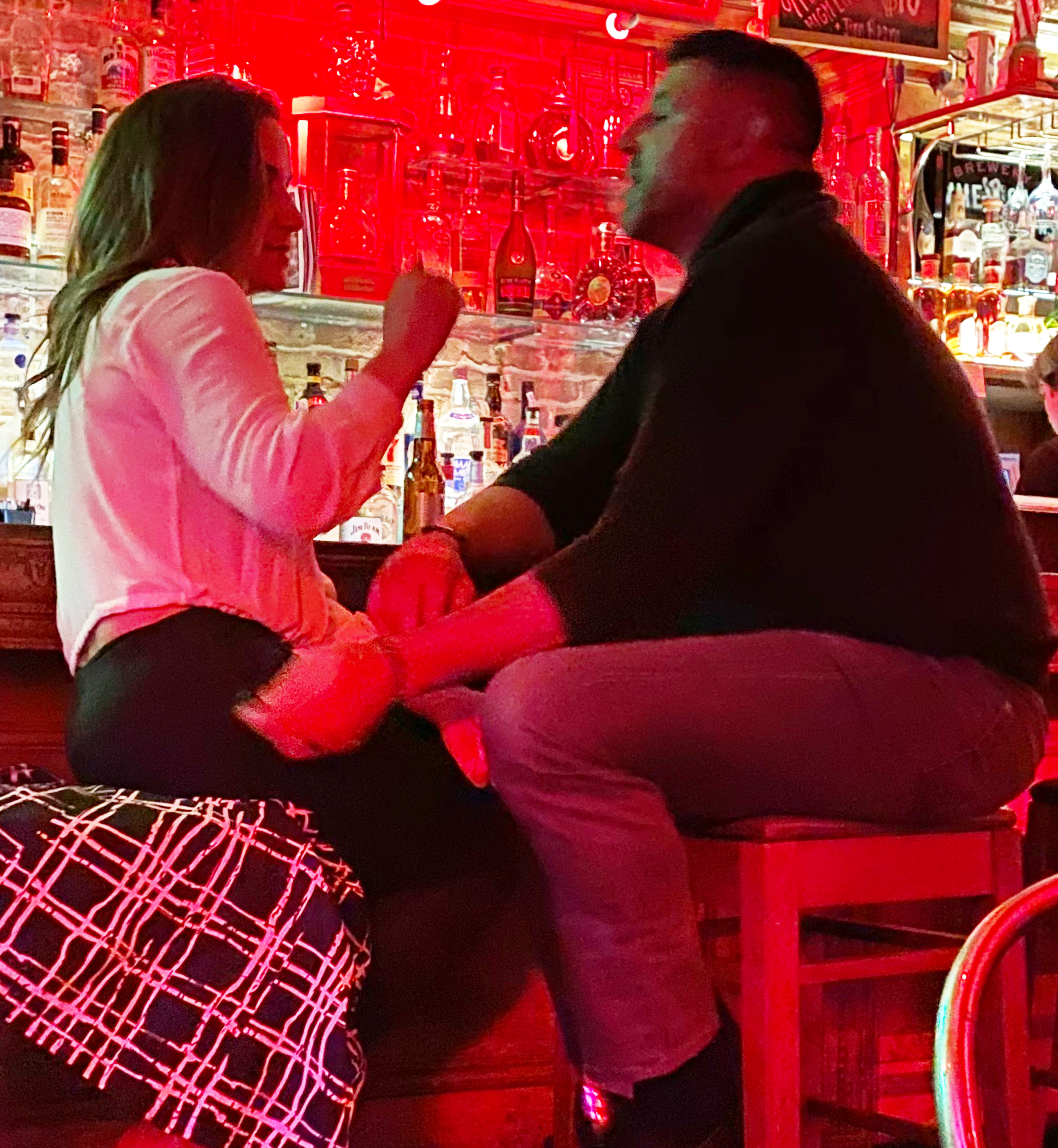 Mike Vrabel and Dianna Russini chatting at a bar.