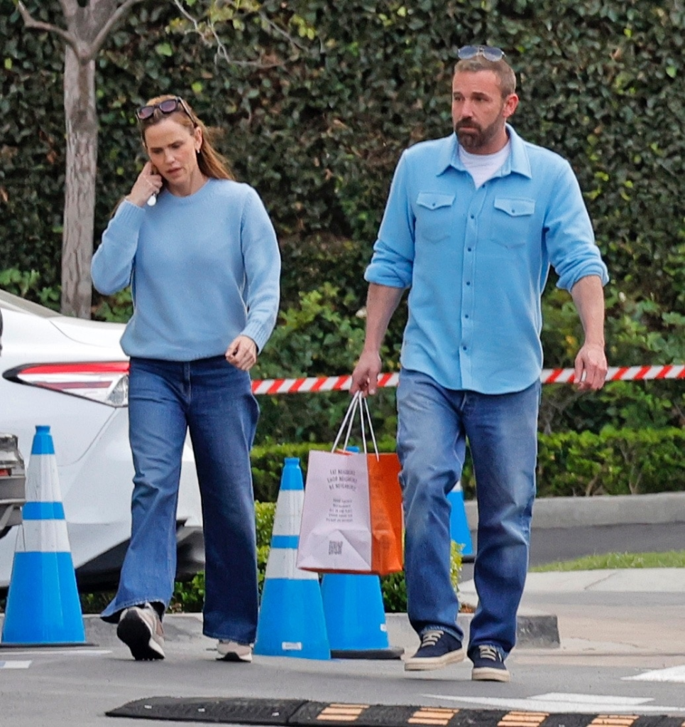 Ben Affleck and Jennifer Garner walking in matching blue sweaters and jeans.
