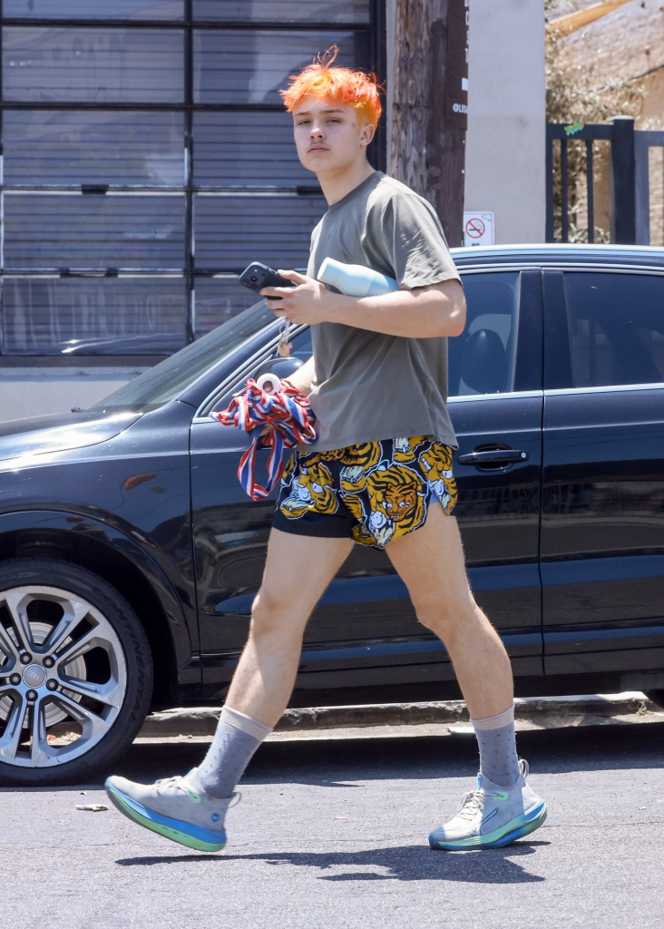 Knox Jolie-Pitt with bright orange hair walking after a Muay Thai class.