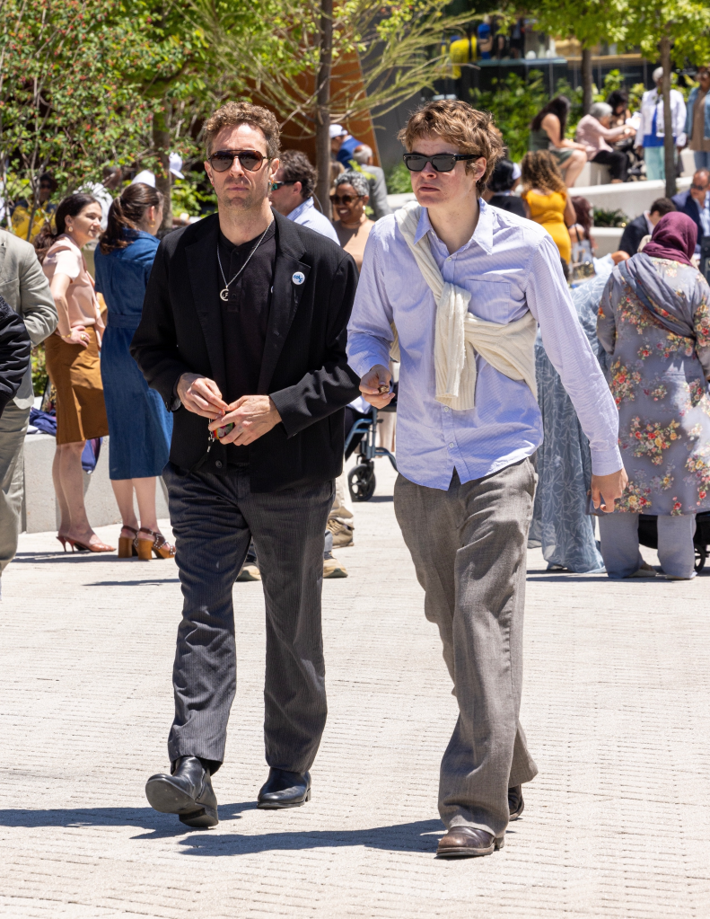 Chris Martin and Moses Martin walk together at Apple Martin's graduation ceremony in Nashville.