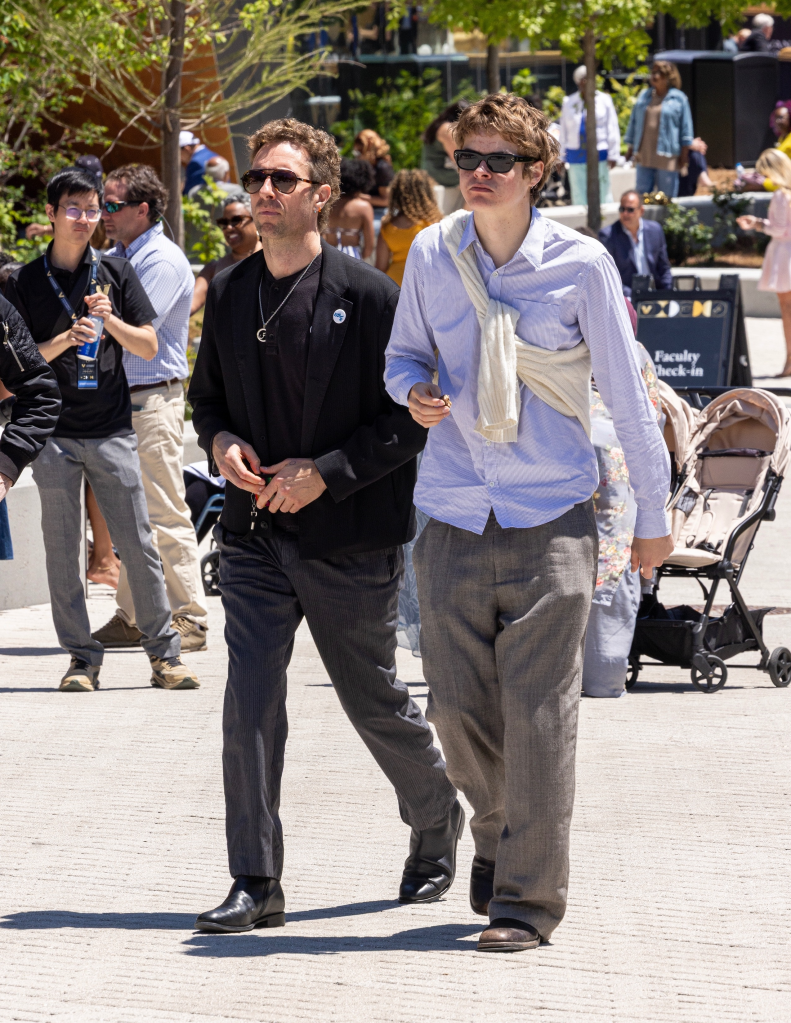 Chris Martin and Moses Martin walk together at Apple Martin's graduation ceremony.