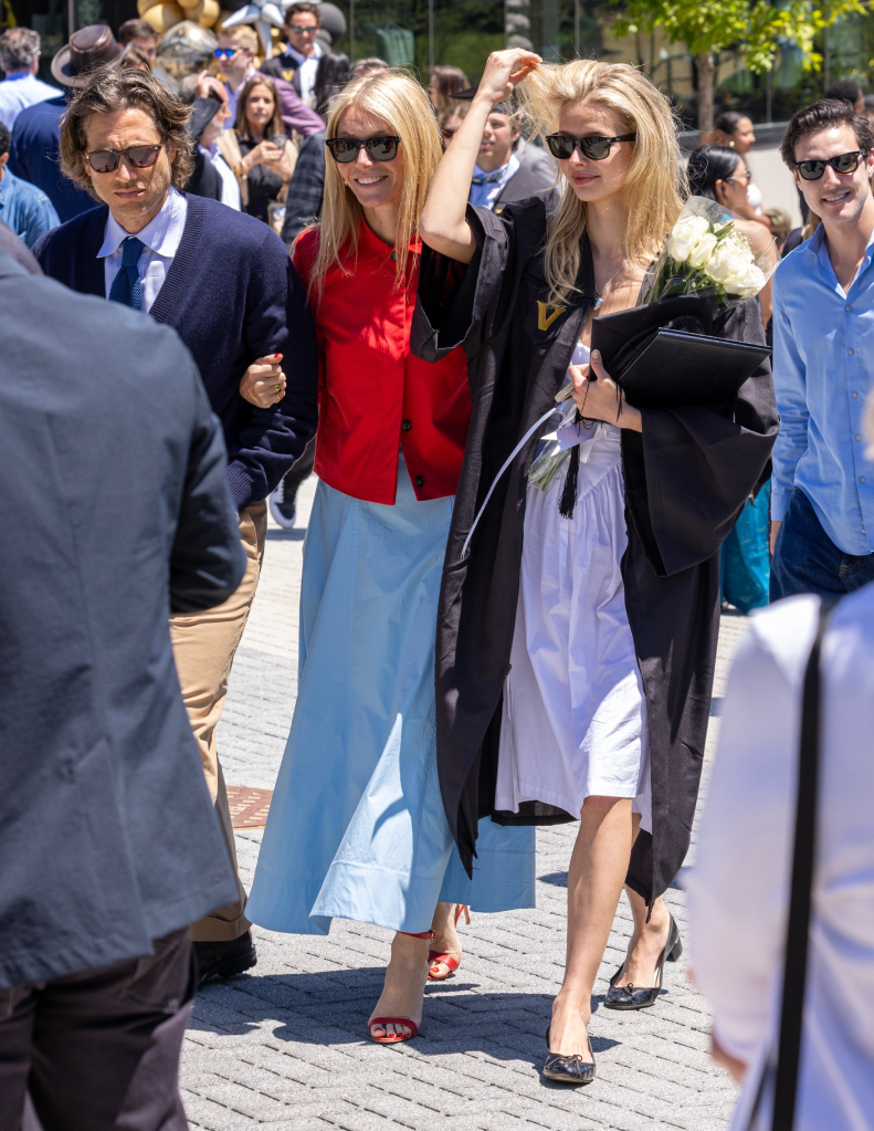 Gwyneth Paltrow, Brad Falchuk, and Apple Martin walking together after Apple's graduation ceremony.