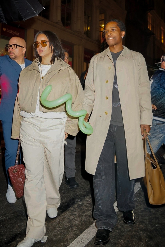 Rihanna and A$AP Rocky walking with a green balloon animal, celebrating RZA's 4th birthday.