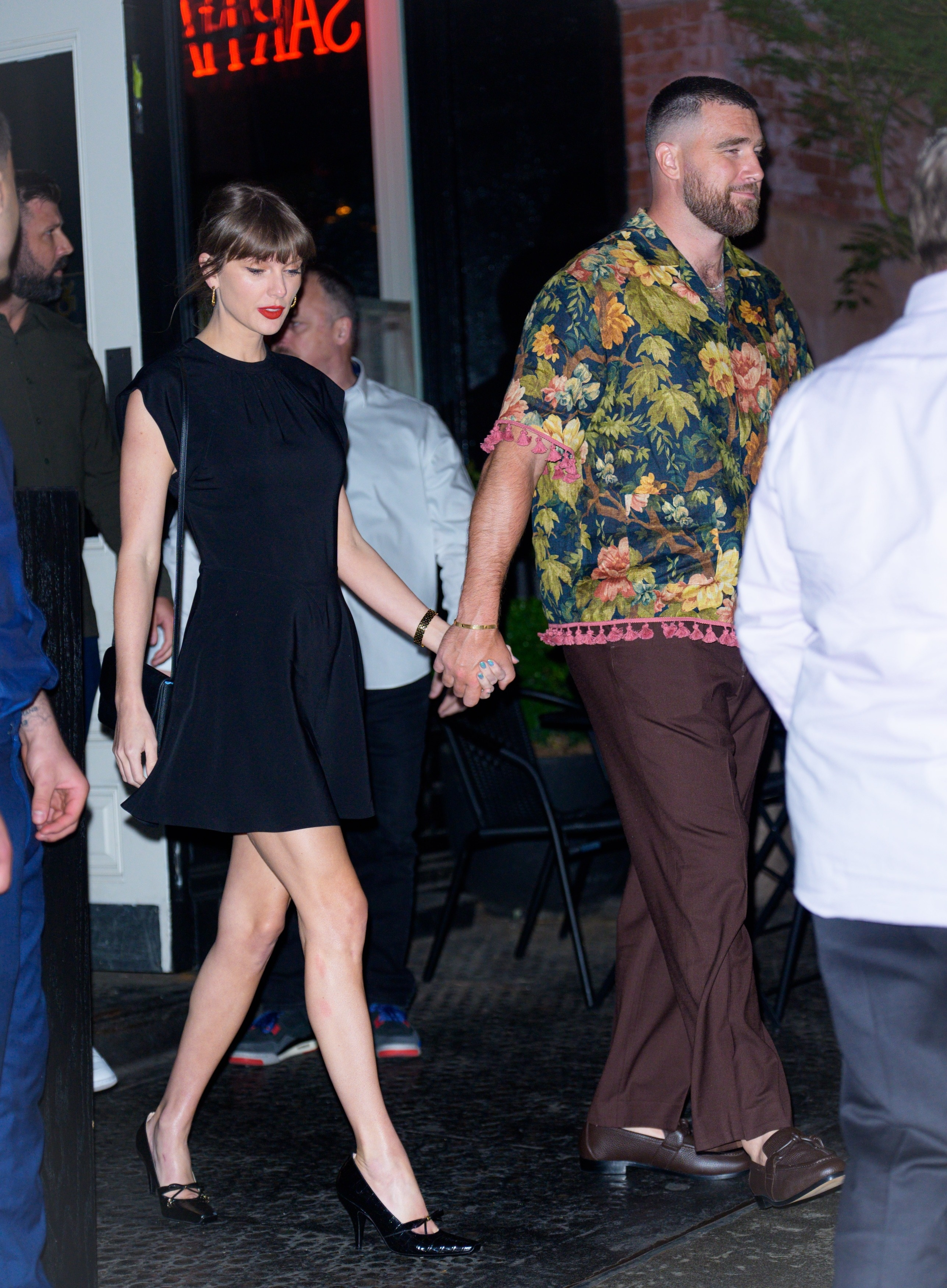 Taylor Swift and Travis Kelce hand-in-hand outside Sartiano's in NYC.