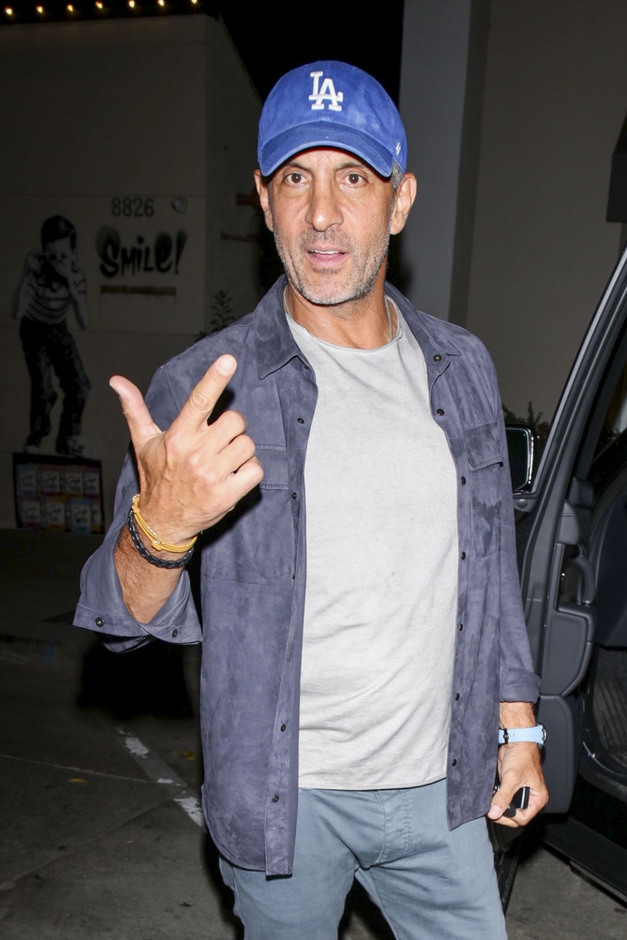 Mauricio Umansky leaving Craig’s in West Hollywood, wearing a blue Los Angeles Dodgers cap.