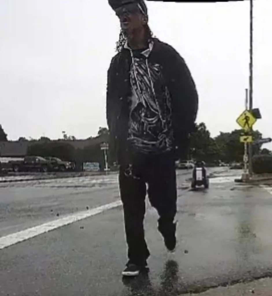 Person walking on a wet street.