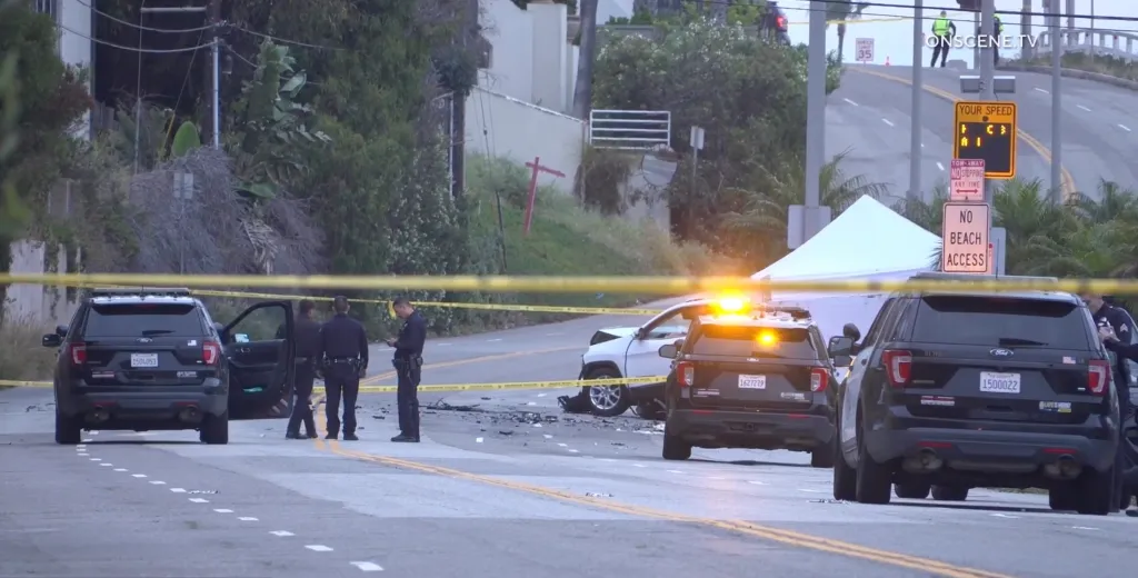 A fatal two-vehicle collision on Culver Blvd and Vista Del Mar in Playa Del Rey, showing damaged cars, police officers, and yellow caution tape across the scene.
