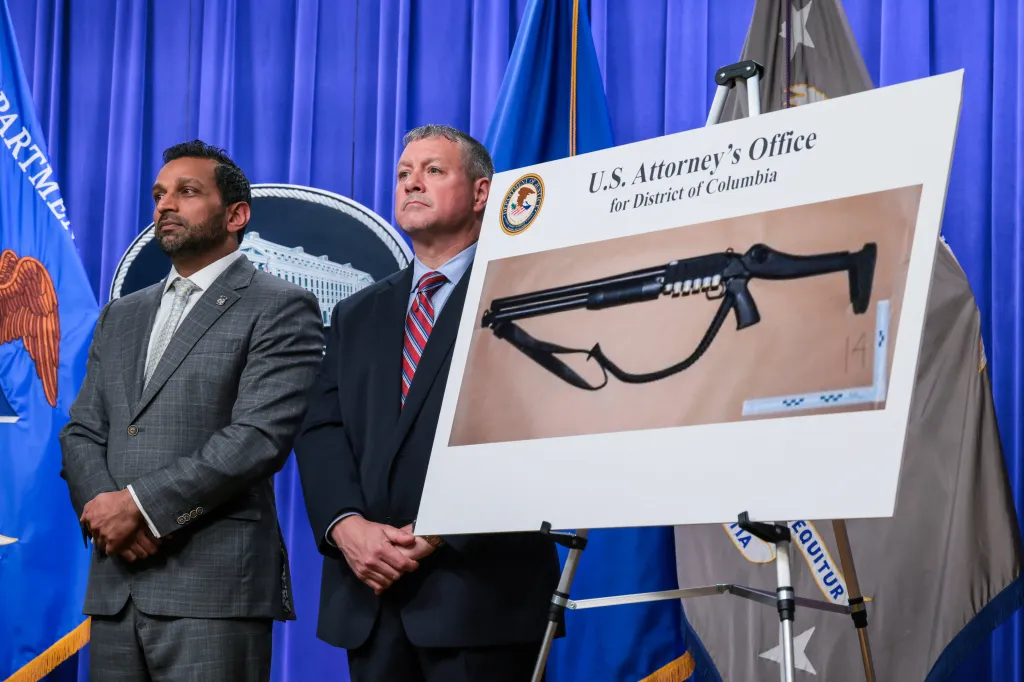 FBI Director Kash Patel and Assistant Director Darren Cox at a press conference with an image of a shotgun.