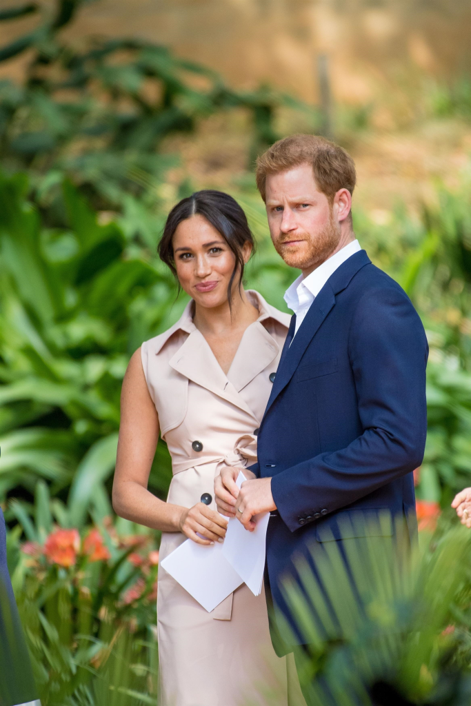 Meghan Markle and Prince Harry stand side-by-side.