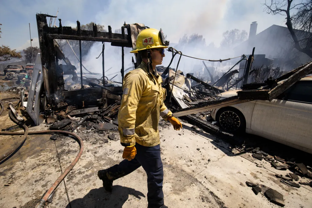 A firefighter assesses damage from the Sandy Fire in Simi Valley, California.