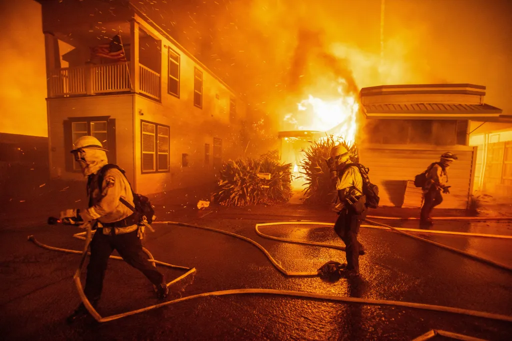 Firefighters battle the Palisades Fire as it burns on the west side of Los Angeles.
