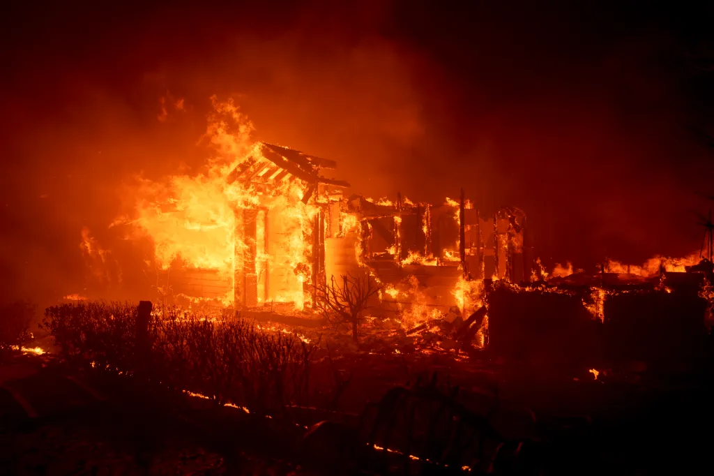 Flames from the Palisades Fire burn a home in the Pacific Palisades neighborhood of Los Angeles, California.