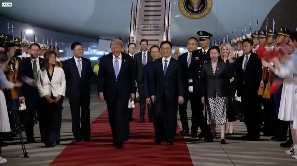 Donald Trump, Elon Musk, and Jensen Huang disembark Air Force One in China.