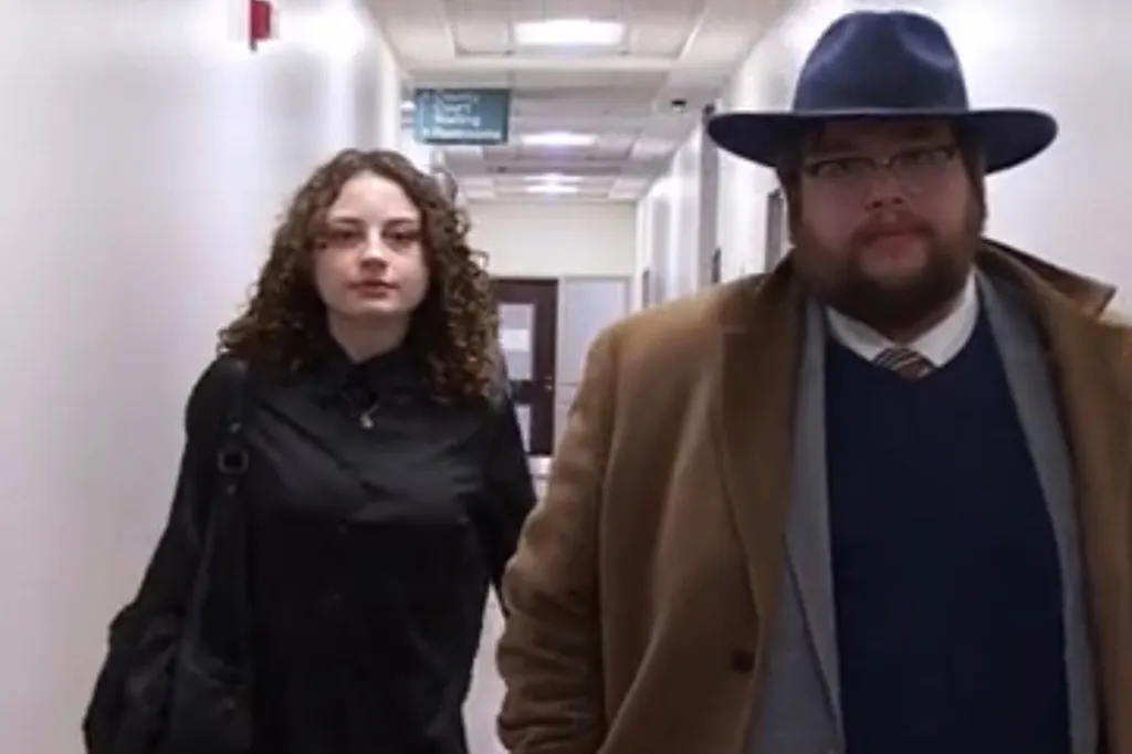 Olivia Henderson and her attorney walking in a hallway.
