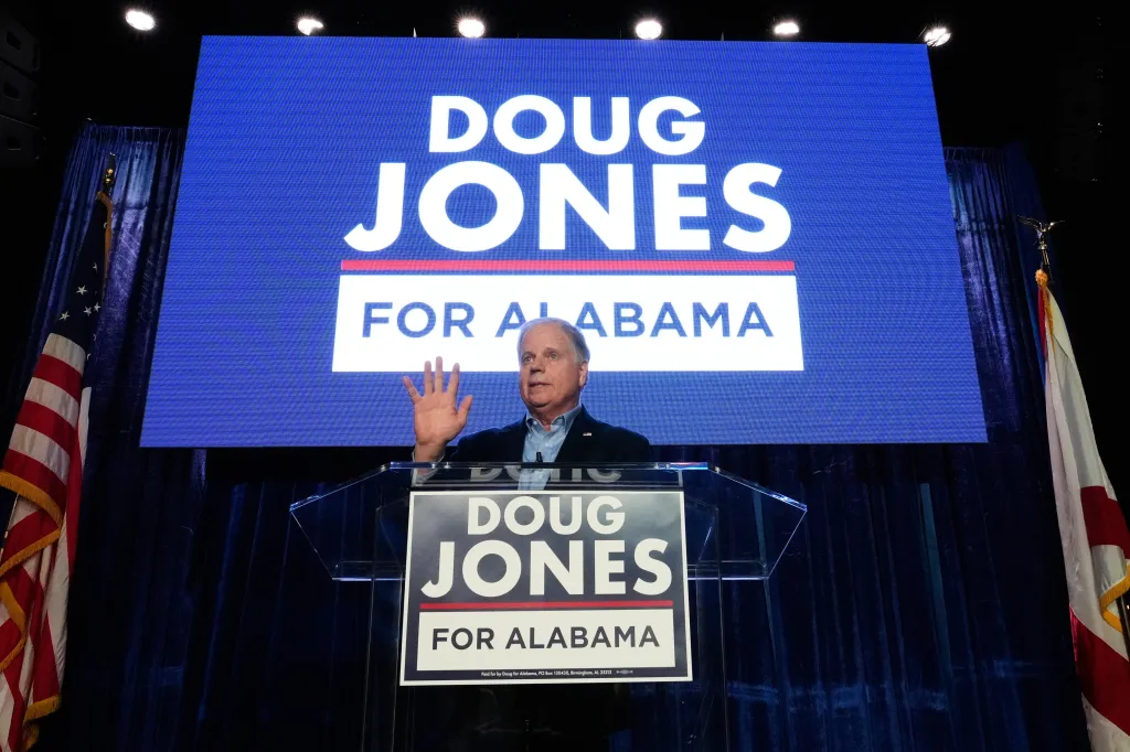 Doug Jones speaking at an event, with 