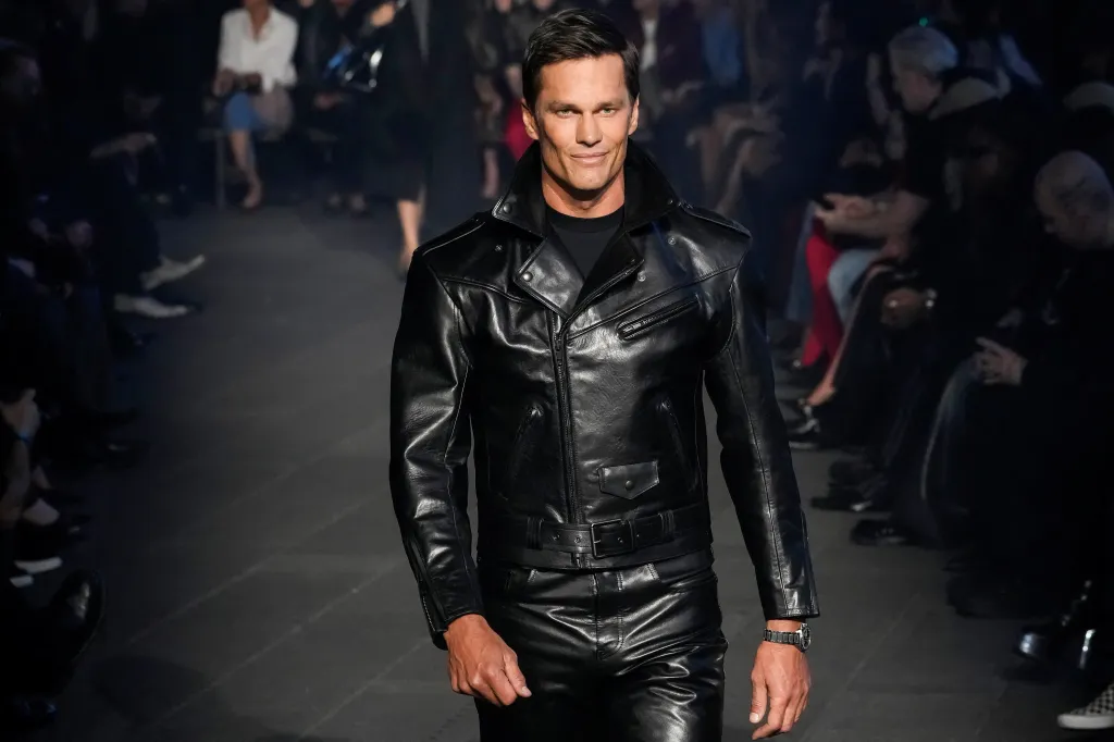 Former U.S. football player Tom Brady modeling a Gucci cruise 2027 collection creation at Times Square.
