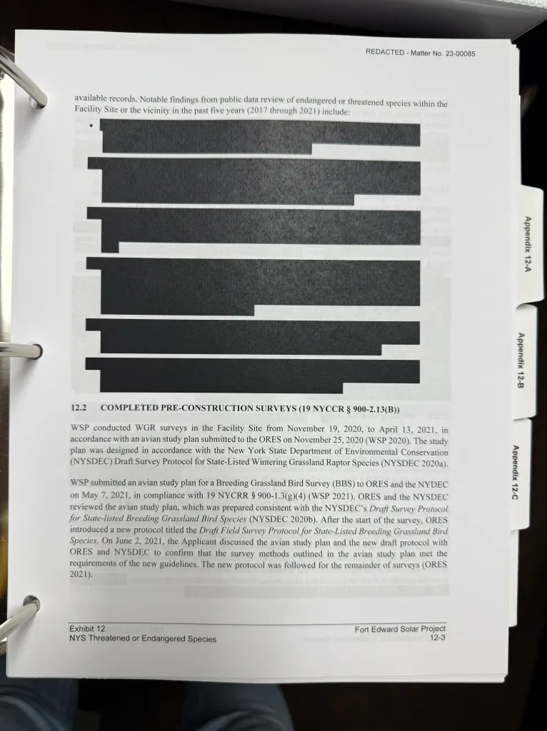 Fort Edward Solar redacted document with black boxes over specific information.
