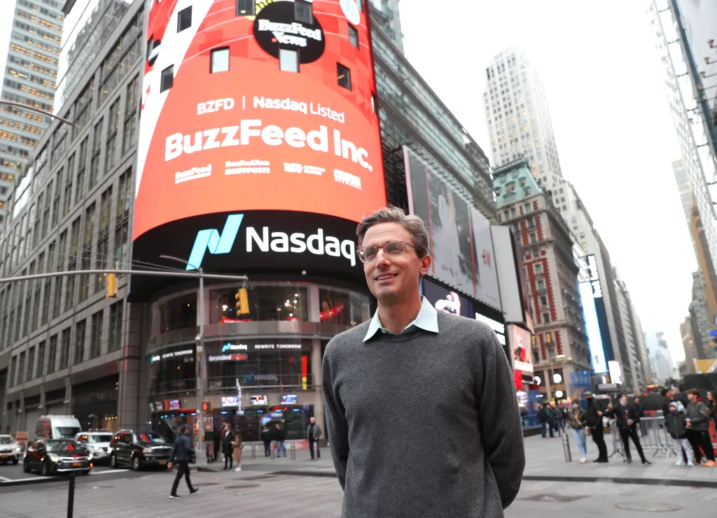 Jonah Peretti, CEO of BuzzFeed, standing in Times Square in front of a large screen displaying 