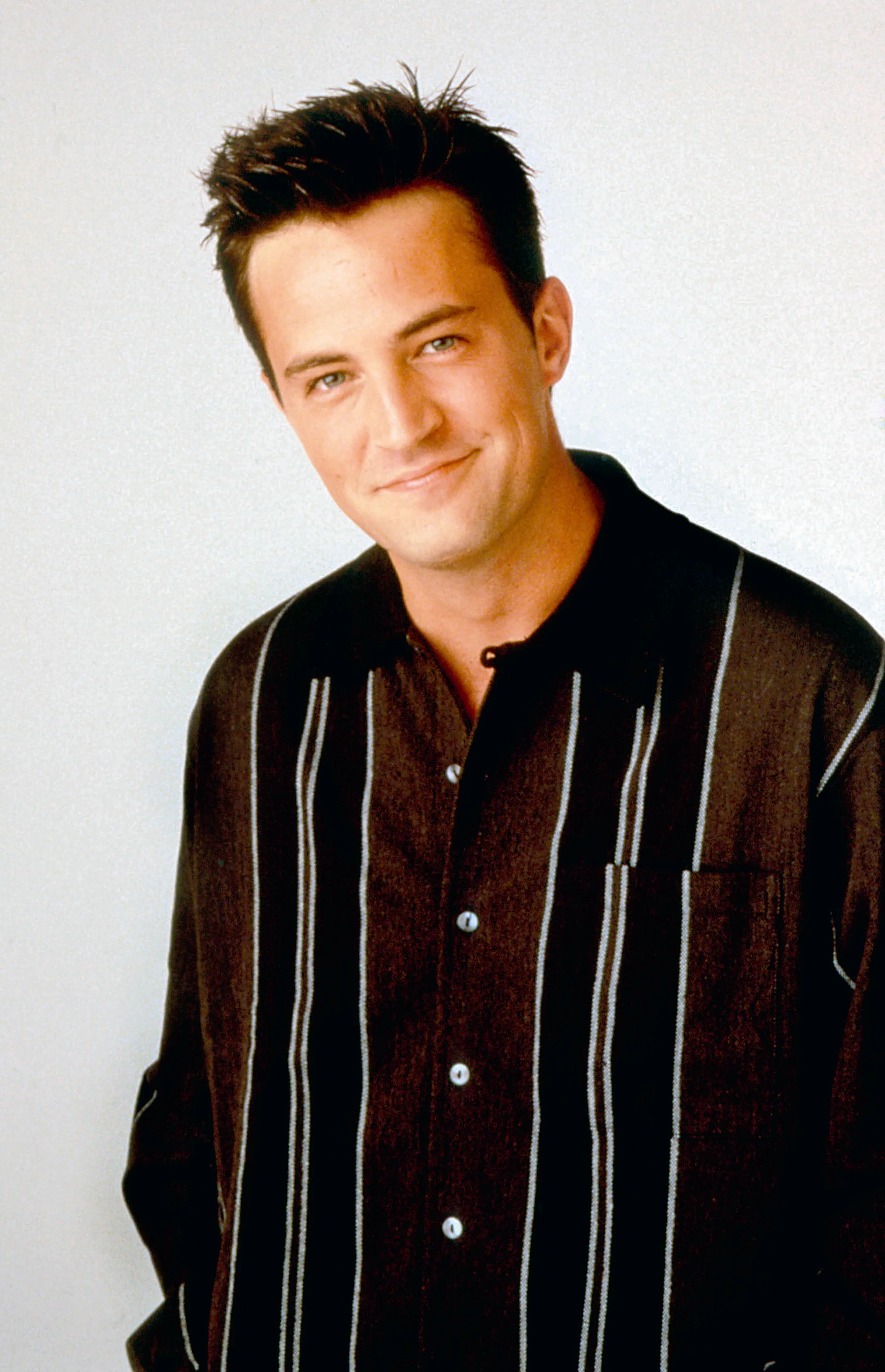 Matthew Perry as Chandler in a brown striped shirt.