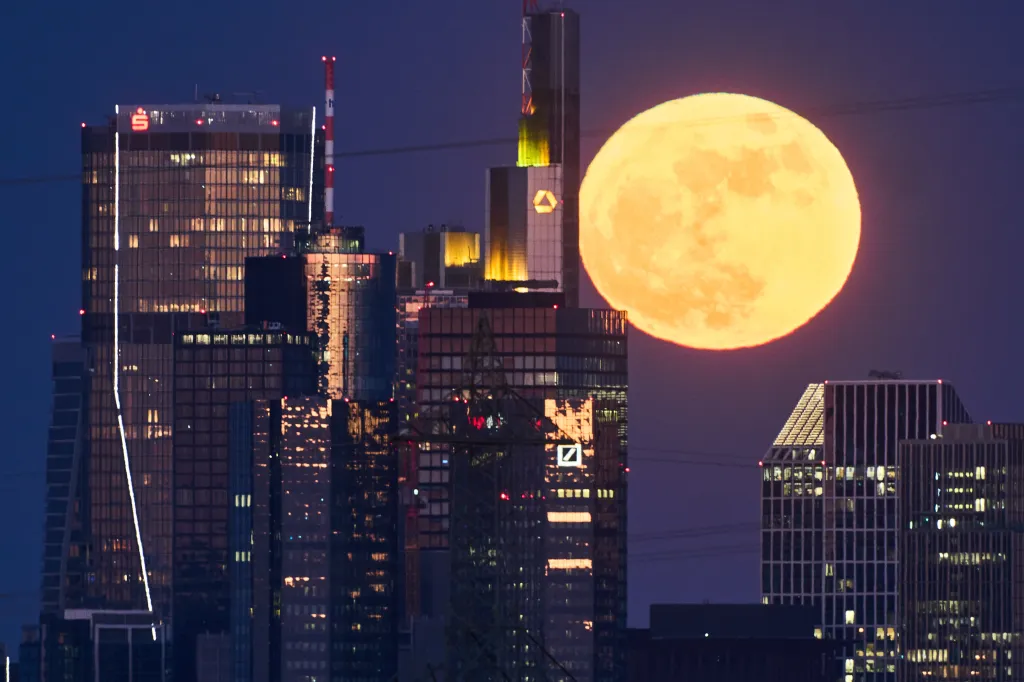 Full moon rising behind the banking district buildings in Frankfurt, Germany.