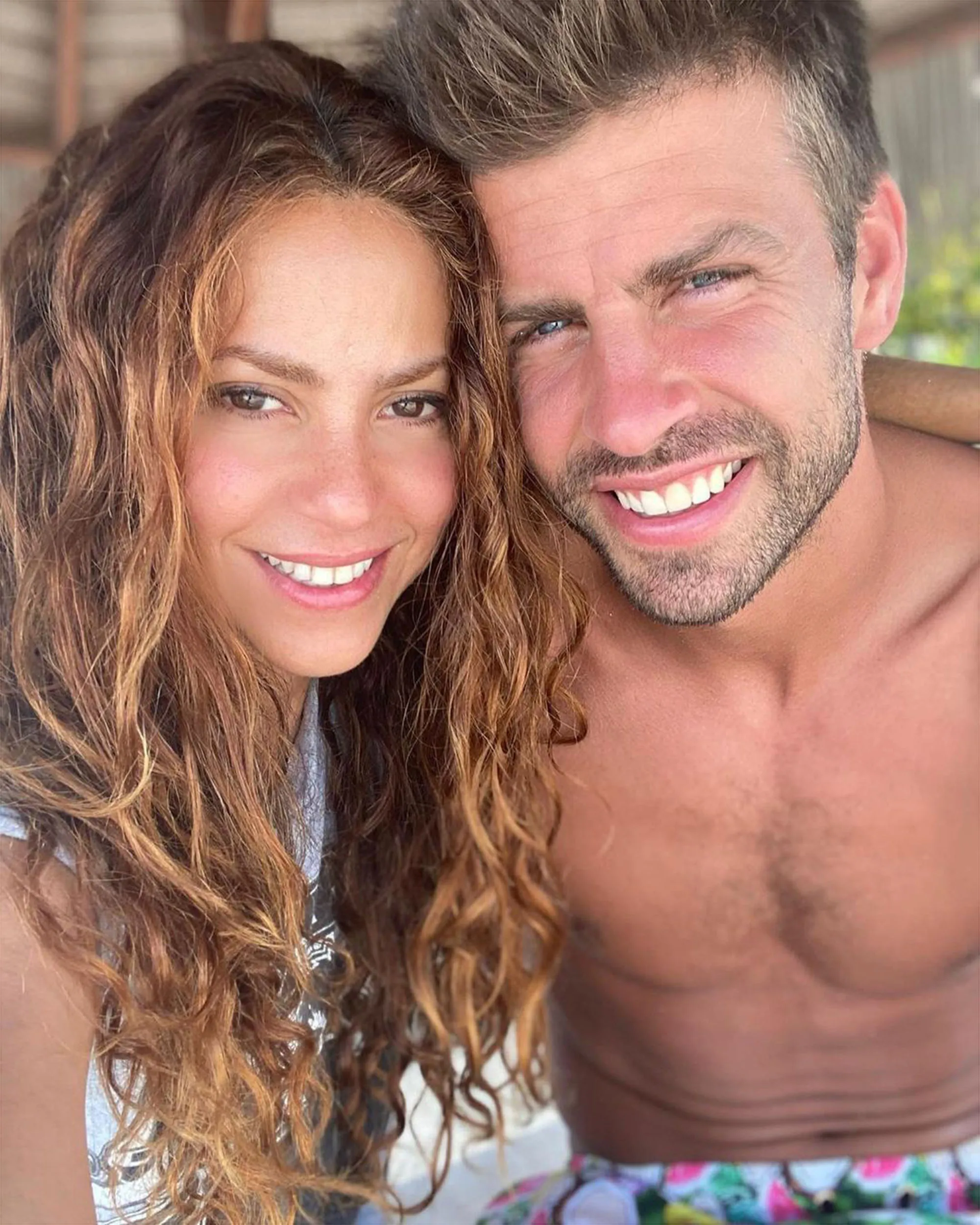 Shakira and Gerard Piqué smiling at the camera.
