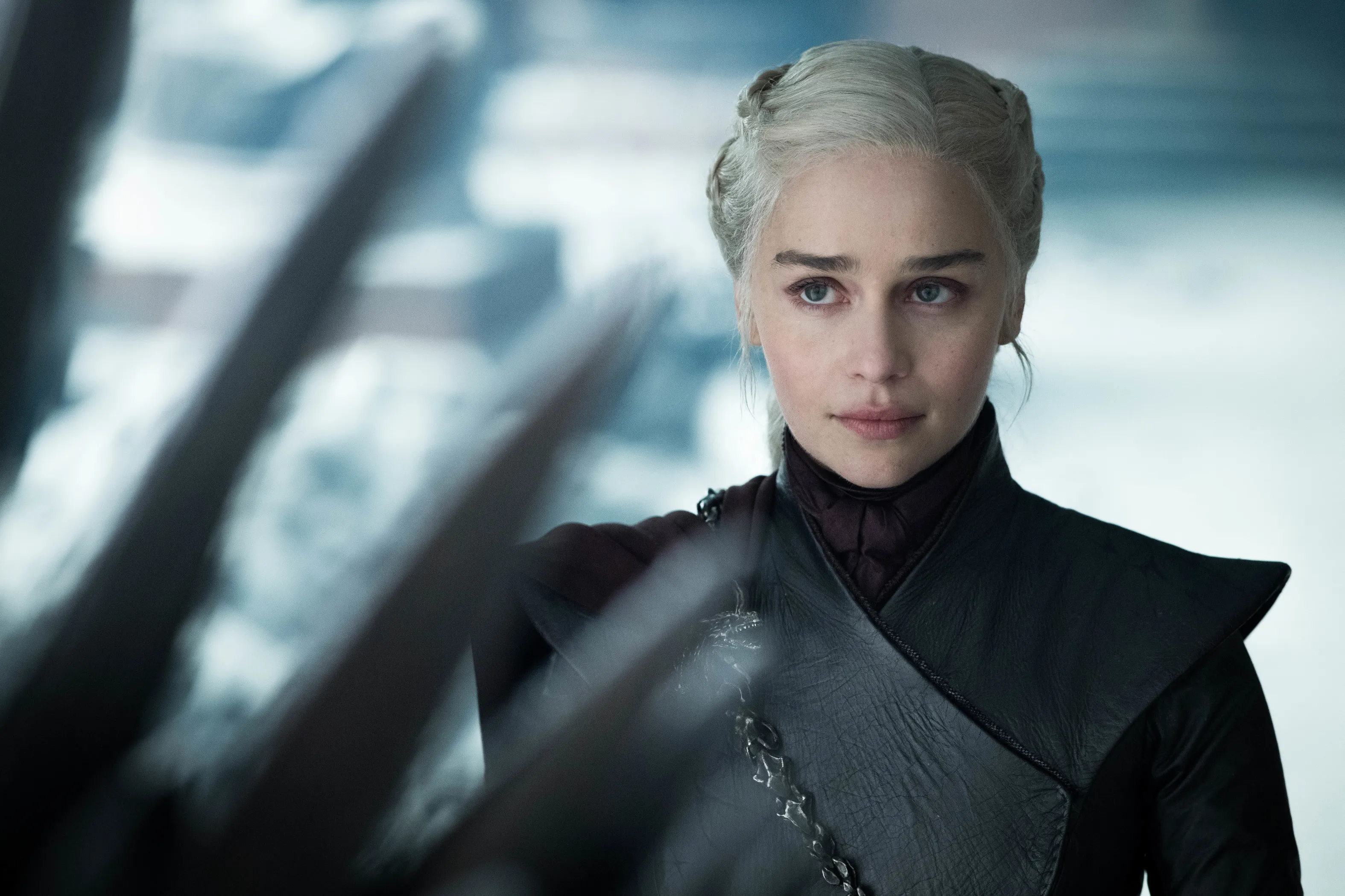 Daenerys Targaryen in a black leather tunic with silver chains across her chest.