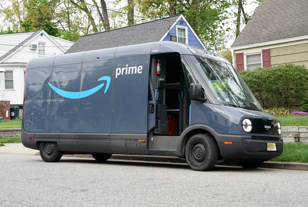 An Amazon Prime Rivian van parked on a street in a residential area.