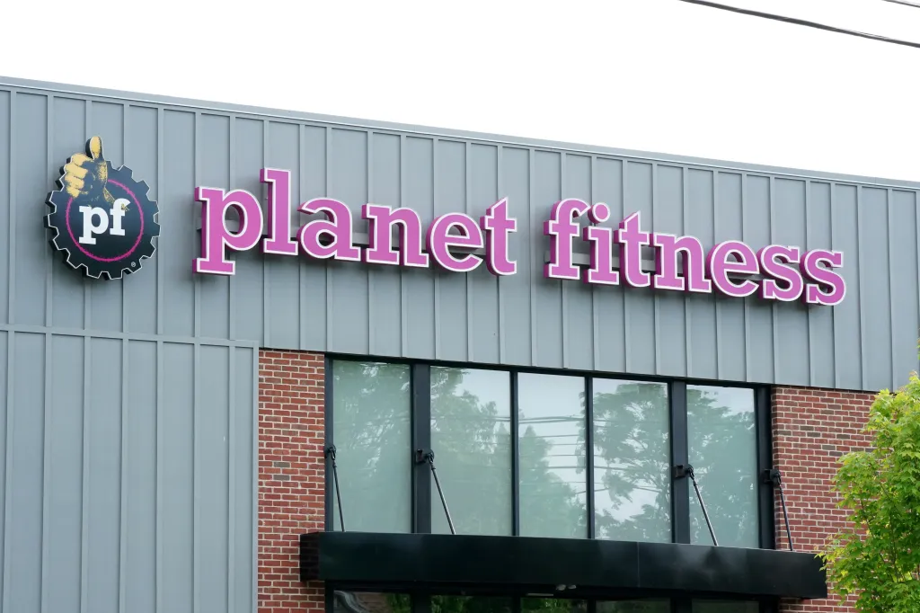 A Planet Fitness sign on the side of a building.