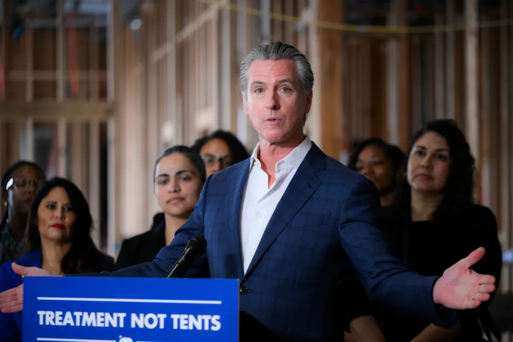 Governor Gavin Newsom speaks at a press conference, with 