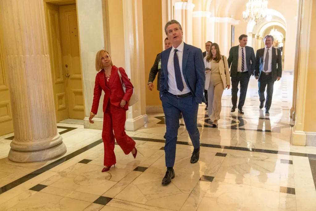 California Governor Gavin Newsom walking through the halls of the U.S. Capitol.
