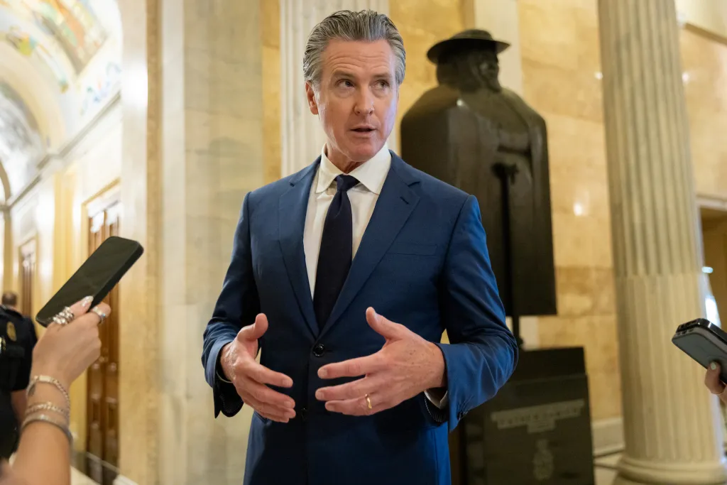 California Governor Gavin Newsom speaking to reporters inside the U.S. Capitol.