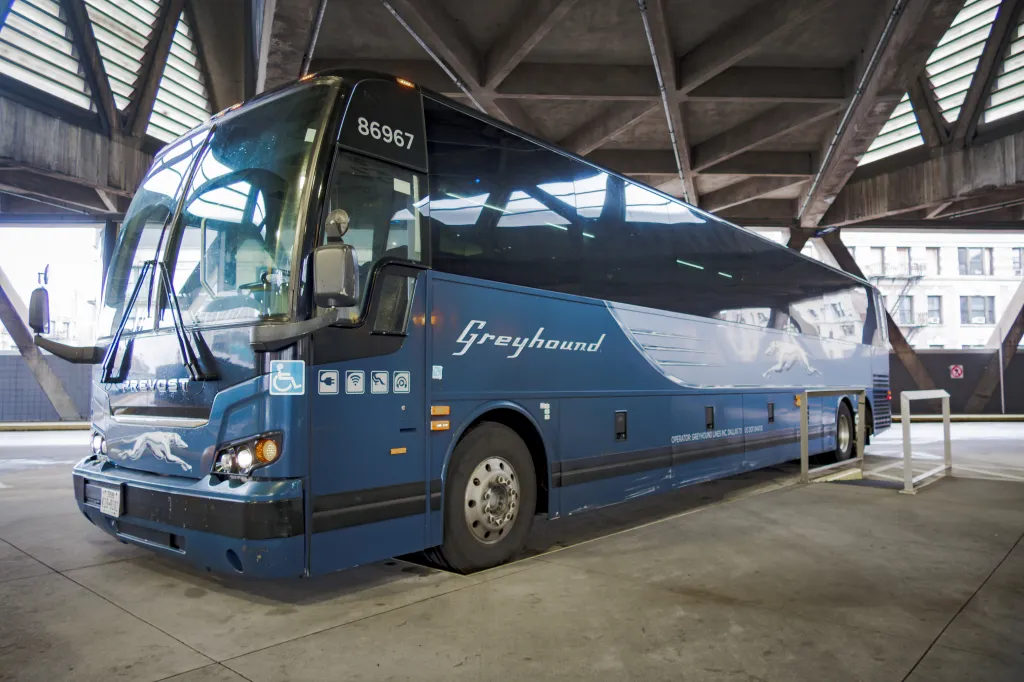 A blue Greyhound bus parked at the GWB Bus Station in Manhattan.