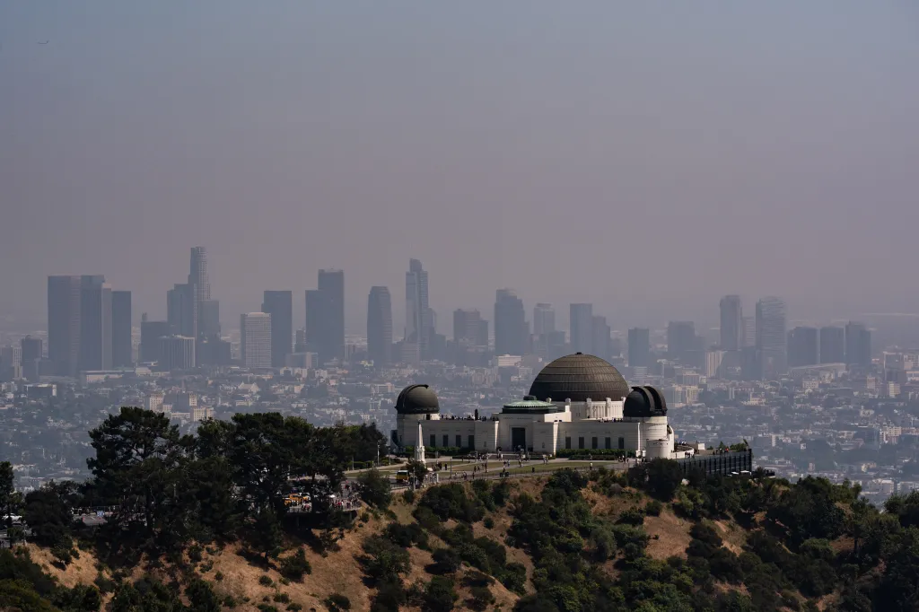 The Griffith Observatory against the hazy Los Angeles skyline.