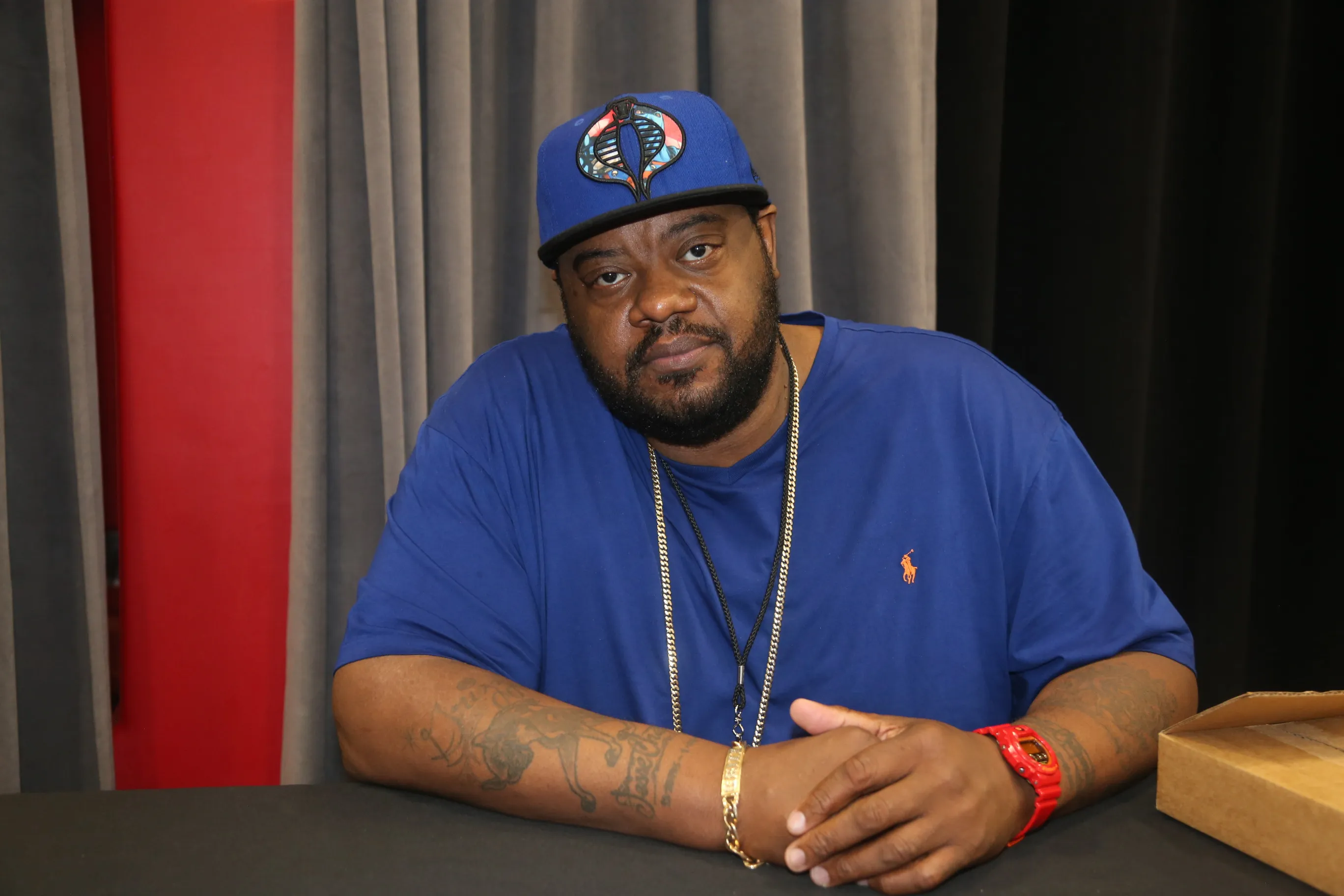 Grizz Chapman in a blue shirt and hat.