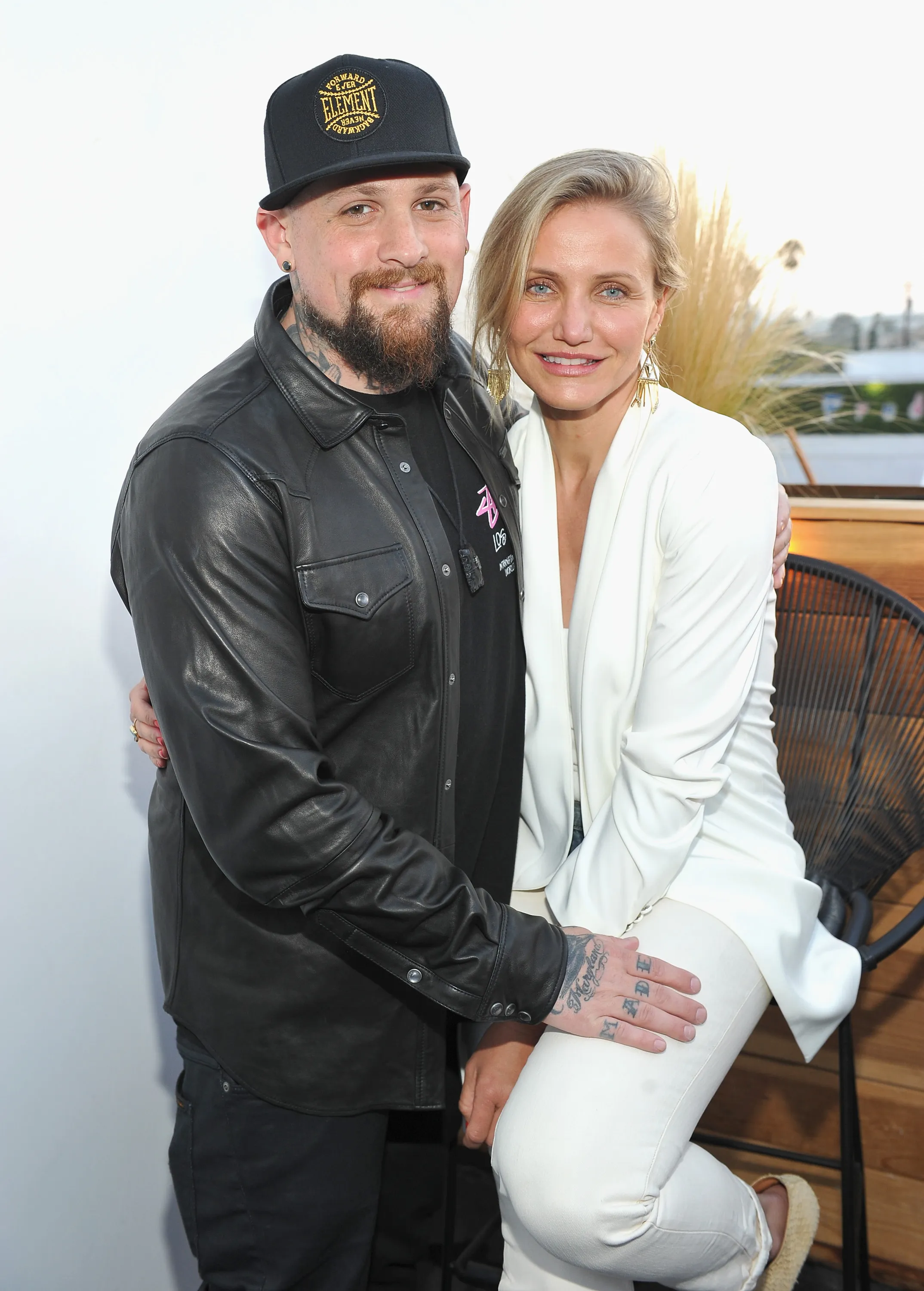 Benji Madden and Cameron Diaz posing together, with Madden's arm around Diaz.