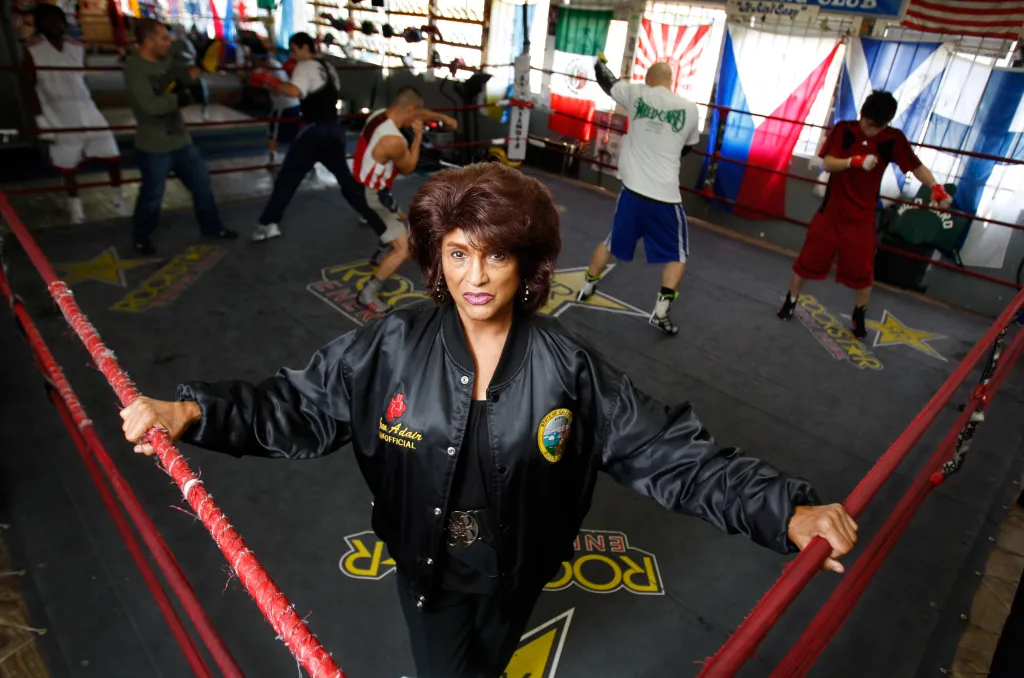 Gwen Adair stands in a boxing ring, the first woman to referee a world title fight and the daughter of the Fatburger founder.
