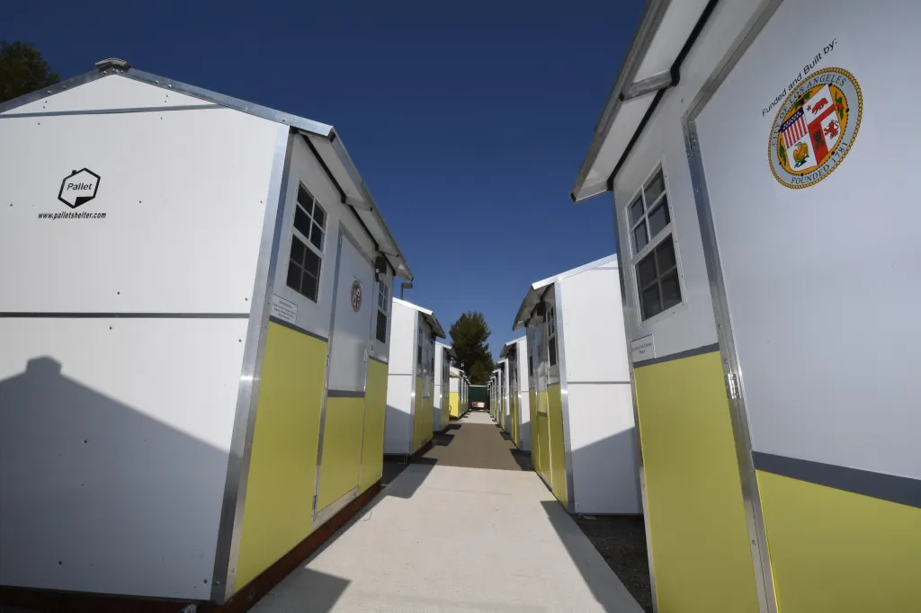 Row of temporary housing units in the Tarzana Tiny Home Village for homeless individuals.