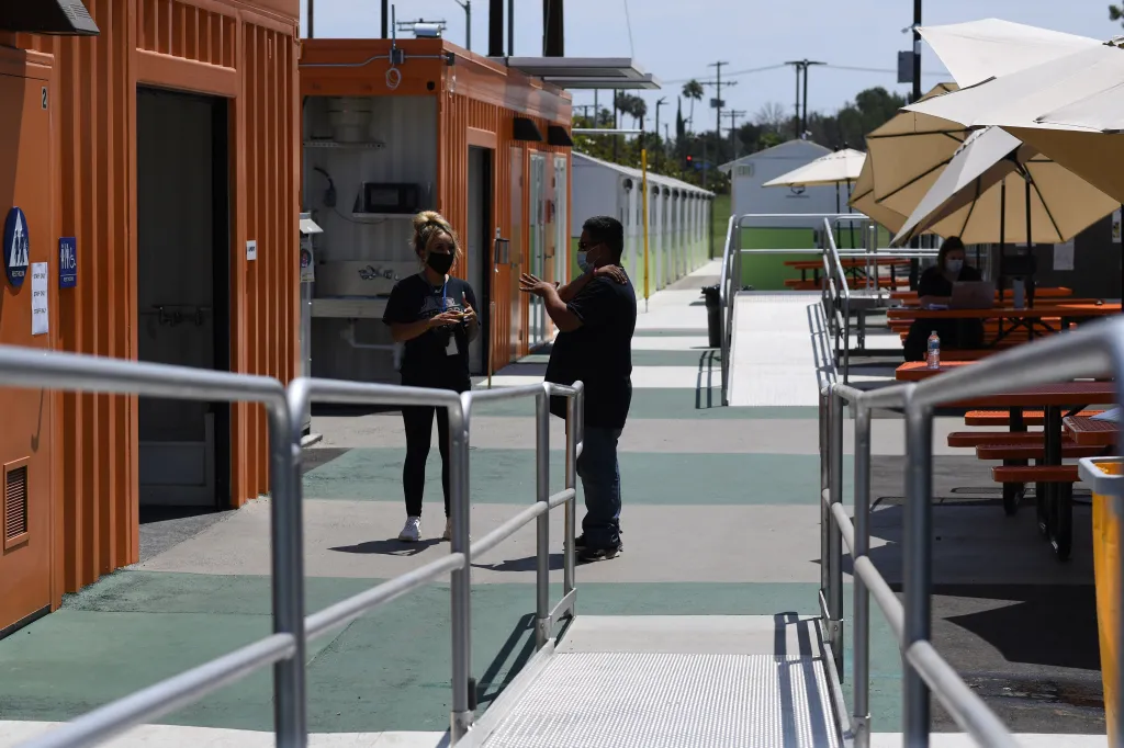 Staff members talking in the common area of the Tarzana Tiny Home Village.