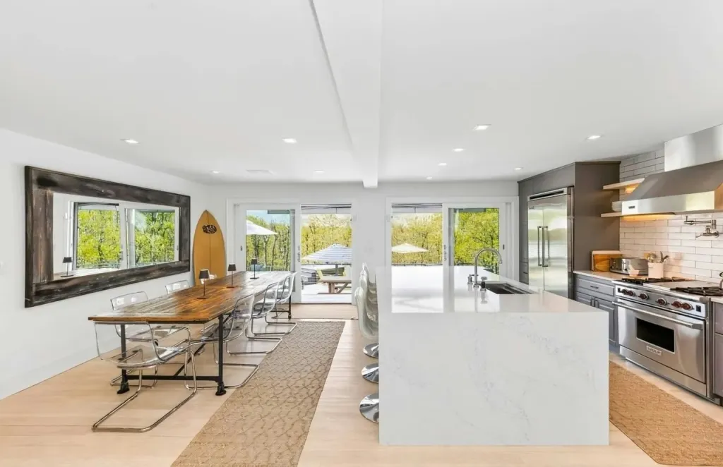 Modern kitchen and dining area with an outdoor view.