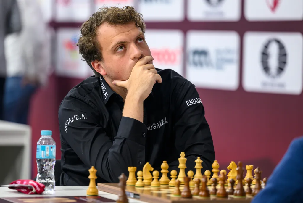 Hans Moke Niemann contemplating his next move in a chess match.