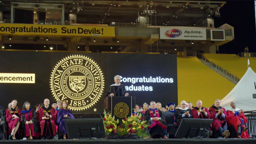 Harrison Ford speaking at a graduation ceremony.