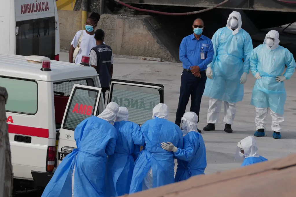 Health workers in protective gear evacuate patients from the MV Hondius cruise ship into an ambulance at a port in Praia, Cape Verde.