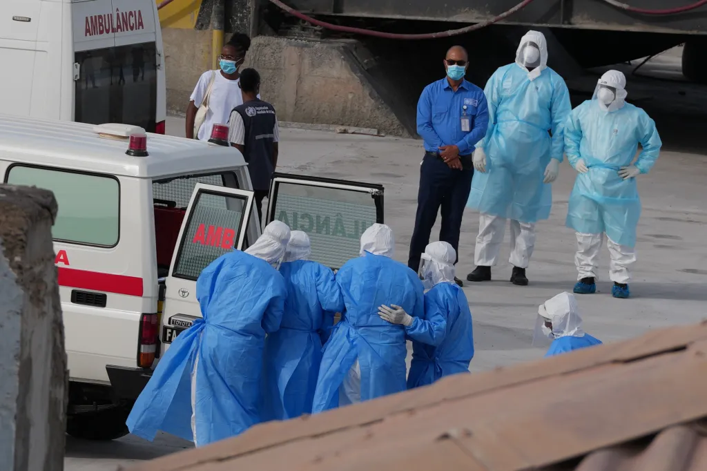 Health workers in protective gear evacuate patients from the MV Hondius cruise ship into an ambulance at a port in Praia, Cape Verde.