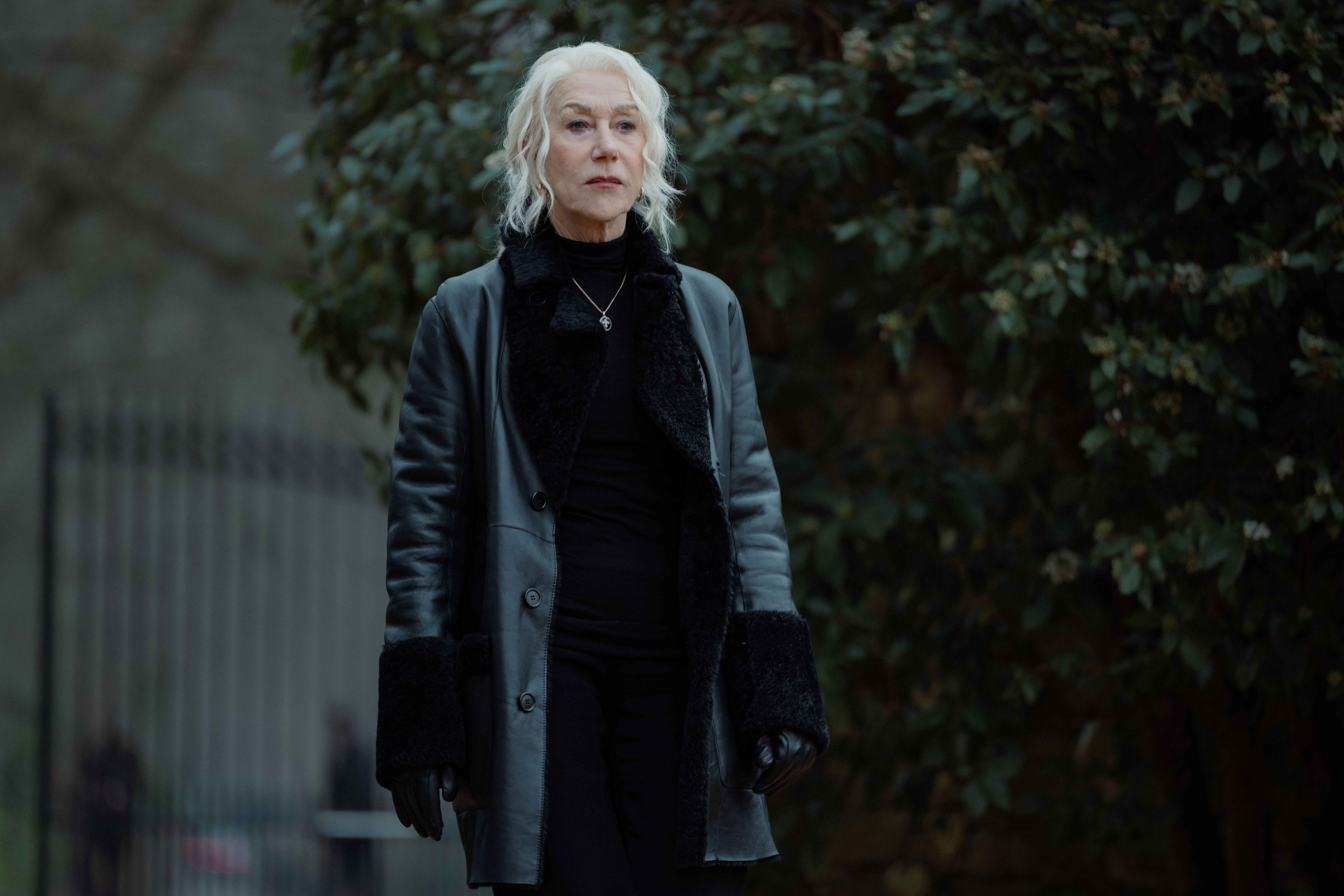 Helen Mirren as Maeve Harrigan in MOBLAND, wearing a black leather coat with black fur trim.