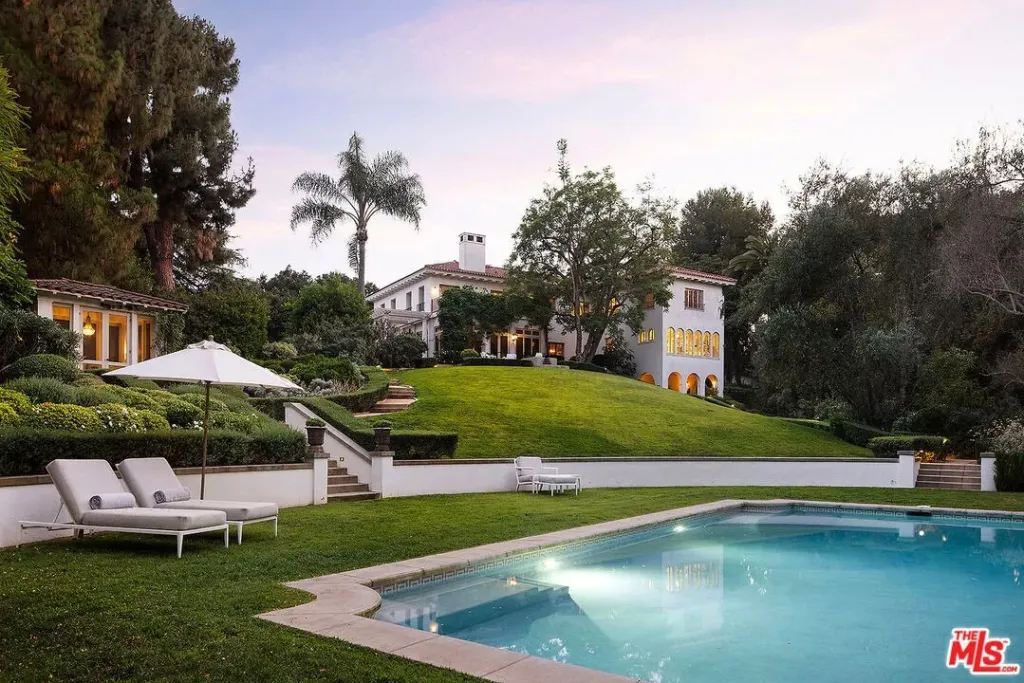 Angelina Jolie's Los Angeles estate featuring a large mansion, lush landscaping, and a swimming pool.