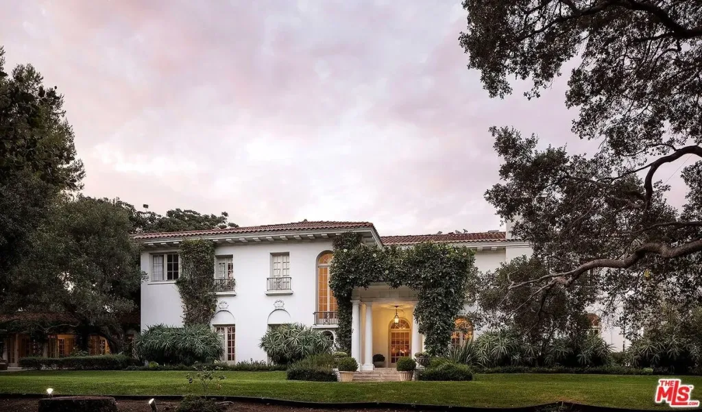 Angelina Jolie's former Los Angeles estate with a white facade and green foliage.