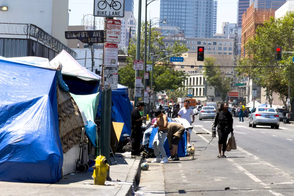 Homeless people and tents line the street in Skid Row, Los Angeles.