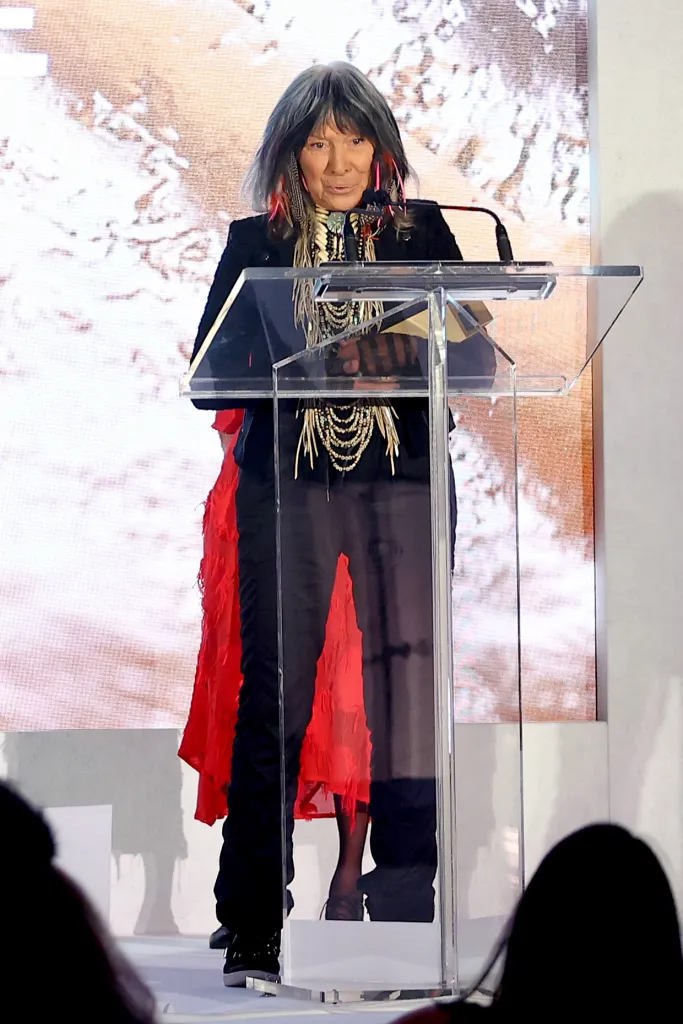 Buffy Sainte-Marie accepting the Jeff Skoll Award in Impact Media at the TIFF Tribute Awards Gala.